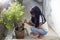 The girl is shoveling the soil for the tree