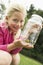 Girl Showing Insect In Jar