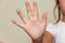 Girl shows five fingers open palm close up