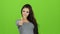 girl shows gesture all right, thumbs up. Green screen