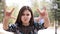 Girl shows horns with his fingers in park