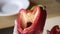 Girl shows red pepper. Red pepper in a cut with all the insides. Girl shows how fresh peppers look. How to choose a pepper.