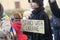 Girl shows a sign with the inscription Stand With Ukraine