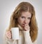 Girl sick with the flu coughs, a mug of tea