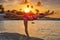 Girl silhouette at beach sunset gymnastics