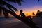Girl silhouette palm tree Caribbean sunset