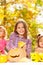 Girl with sisters carve pumpkins for Halloween