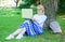 Girl sit grass lean tree trunk with notebook. Lady freelancer working in park. Wi fi network connection free access