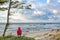 Girl sits on the beachfront and looks into the distance