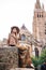 A girl sits on the Boniface bridge overlooking the Church of our lady of Vrouwekerk in Bruges