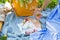 A girl sits on a colorful picnic on the nature-wine, strawberry, cheese, cake