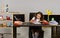 Girl sits at desk near shelves with colorful stationery