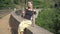 Girl sits on famous old bridge located among wildlife nature