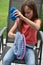 Girl sits in the garden and learns knitting