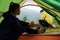 Girl sits inside of tent and looks at boyfriend. Majestic Carpathian Mountains. Beautiful landscape of untouched nature