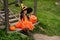 A girl sits on the ladder in front of the house on Halloween