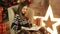 Girl sits and reading a book in a Christmas room