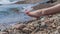 Girl sits on the shore of Baikal.