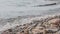 Girl sits on the shore of Baikal.