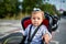 Girl sitting in a baby bike seat of a bicycle of her father safety emotions anxiety kids children parenting.