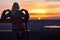 Girl sitting on a banch at sunset