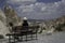 Girl sitting on a bank, enjoying the majestuosity of Capadocia Landscape in Turkey