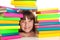 Girl sitting behind pile of books