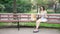 Girl sitting on a bench finds a book in a bag and begins to read