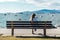 Girl Sitting on a Bench at Kitsilano Beach in Vancouver, Canada