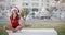 Girl Sitting on a Bench in Santa Hat