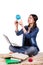 Girl sitting on the carpet with a globe, a laptop and books