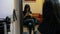 Girl sitting on chair and texting on mobile phone at beauty salon