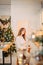 Girl sitting in Christmas decorated kitchen and thinking about future plans