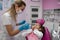 girl is sitting dental chair does not want to treat her teeth by showing appropriate gestures