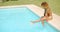 Girl Sitting At the Edge of Swimming Pool