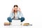 Girl sitting on floor in headphones near laptop, books and copybooks