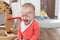 Girl sitting on the floor at home and crying. One year old baby crying