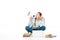 Girl sitting on floor with loudspeaker near laptop, books and copybooks