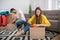 Girl sitting with flowerpot in the hands, man closing box