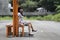 Girl sitting on an iron bench