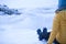 Girl sitting with mountain boots with crampons on the ice