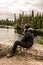 Girl sitting near Lake of two rivers in Algonquin National Park Canada Ontario natural pinetree landscape