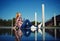 Girl sitting next to the water with reflection of her self