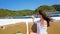 Girl sitting on the nose of the speedboat. Hair fluttering in the wind, glasses in front of his eyes.