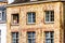 Girl sitting in an open window with a modern mobile phone in a historic brick house in the medieval city of Bruges, Belgium