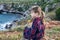 Girl sitting at a picturesque rocky coastline