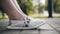 The girl is sitting relaxed on a bench in the Park. Close - up of her legs. Good weather.