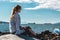 Girl Sitting on a Rock at Kitsilano Beach in Vancouver, Canada