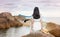 Girl sitting on the seaside rocks