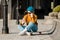 Girl sitting on skateboard and use mobile phone. Outdoors, urban lifestyle. cute skater girl sitting on skate board checking smart